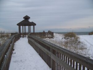Picture of the OBX beach filled with snow. There to help buyers see what it is like to purchase in different seasons.